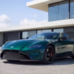 Green-Aston-Martin-Vantage-luxury-grand-tourer-parked-outside-a-modern-estate