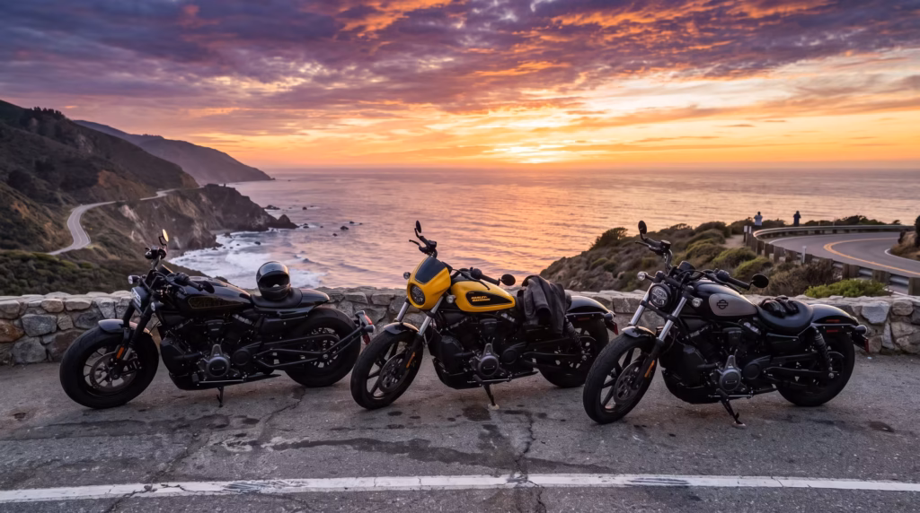 Three Harley-Davidson sport motorcycles lined up on the side of a coastal highway overlooking the ocean during a vibrant sunset.