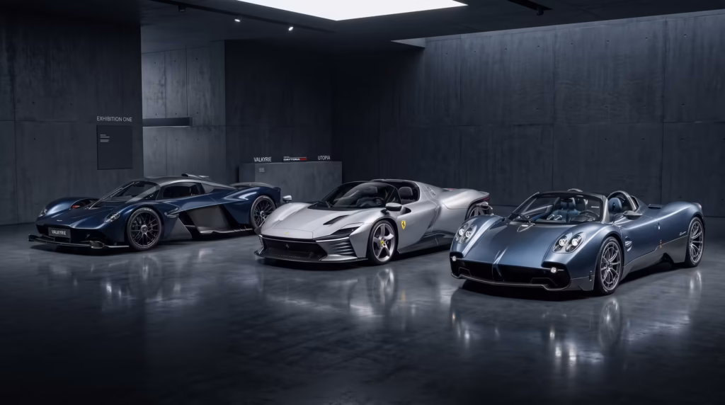 Three ultra-exclusive modern hypercars and luxury sports cars parked in a staggered formation inside a premium, dark minimalist collector's gallery with dramatic studio lighting.